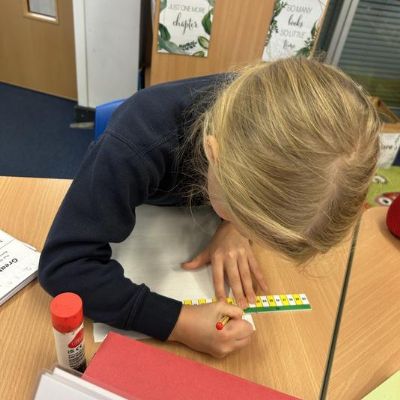 Learning how to use a ruler correctly to underline our own date and title!