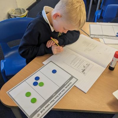 Using 6 counters and a place value grid.